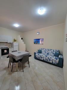 a living room with a table and a couch at Appartamenti Vincenzo Lampedusa in Lampedusa