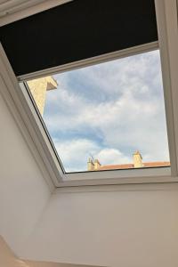 a skylight window in a roof at Cozy Paris Gateway Studio with free parking in Vitry-sur-Seine