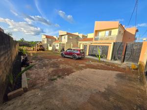 a red car parked in front of a house at Safim Suites in Plaque