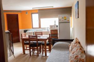 a kitchen with a table and a dining room at Departamento Confluencia in Neuquén