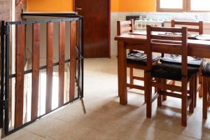 a dining room with a table and a table and chairs at Departamento Confluencia in Neuquén +4 photos