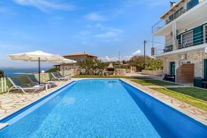 a swimming pool in a villa with a view of the ocean at Gkountis stone apartment 5 in Tsoukaladhes