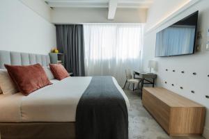 a bedroom with a large bed and a table at Vain Boutique Hotel in Buenos Aires +97 photos