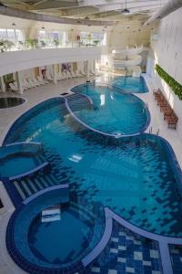 a row of swimming pools in a large building at Cabana Corbu Băile Figa in Beclean