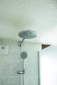 a shower head in the ceiling of a bathroom at Campanile Nantes Saint-Sébastien-Sur-Loire in Saint-Sébastien-sur-Loire +33 photos