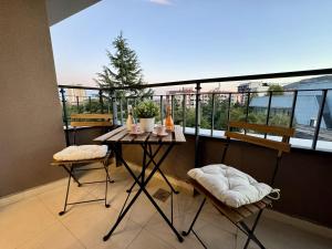 a balcony with a table and two chairs and a window at Maria Luxury Apartment in Skopje