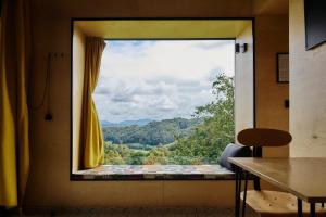 a window with a view of a mountain view at Tri Vile Estate, a piece of paradise in Kozjansko in Podčetrtek