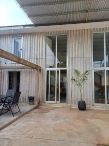 a house with sliding glass doors and a palm tree on a patio at TemporarioCasaLoft in Posadas