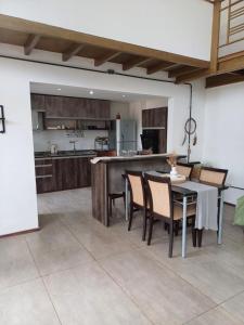 a kitchen and dining room with a table and chairs at TemporarioCasaLoft in Posadas