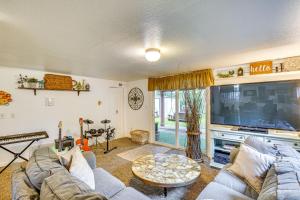 a living room with a couch and a tv at Hot Tub and Fireplace Peaceful Anderson Island Home in Johnson Landing