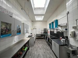 a large kitchen with counters and a sink in it at Ullswater Hotel in Bournemouth