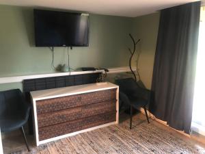 a living room with a flat screen tv on the wall at Sugar Buzz (B8) in Cedar