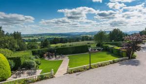 a garden with a view of the hills at Roundthorn Country House & Luxury Apartments in Penrith
