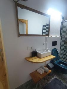 a bathroom with a sink and a mirror on the wall at Tarihi Restore Edilmiş Rum Evi in Ayvalık +32 photos