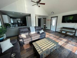 a living room with a couch and a ceiling fan at Cozy Getaway in Mullan in Mullan