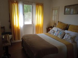 a bedroom with a large bed in front of a window at Chalet Las Doritas in La Cumbre +44 photos