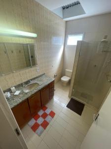 a bathroom with a shower and a sink and a toilet at Casarão DM in Domingos Martins
