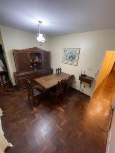 a dining room with a wooden table and chairs at Casarão DM in Domingos Martins +41 photos