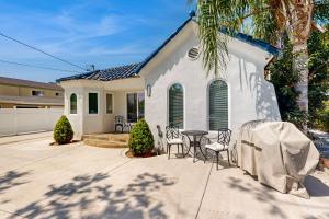 a house with a table and chairs in front of it at Sunshine Fun Time in Newport Beach