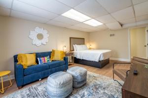 a living room with a bed and a blue couch at Affordable 4-Bedroom Retreat Near DT Cartersville in Cartersville