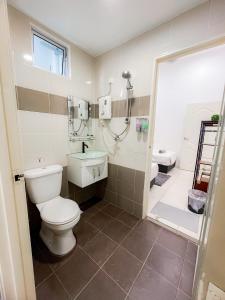 a bathroom with a toilet and a shower and a sink at KotaSas Summer East Persint 5 by AHM Home in Kuantan +39 photos