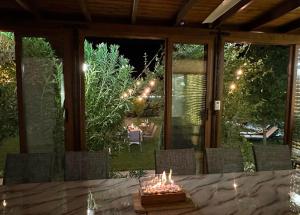 a patio with a table with candles on it at Guest House Doni in Sandanski