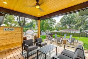 a patio with chairs and a table and a grill at Stylish and Modern Lenexa Haven with Fire Pit and Deck! in Lenexa