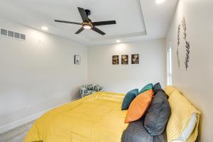 a bedroom with a bed and a ceiling fan at Stylish and Modern Lenexa Haven with Fire Pit and Deck! in Lenexa