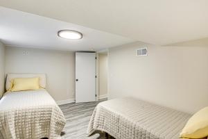 a bedroom with two beds in a room at Stylish and Modern Lenexa Haven with Fire Pit and Deck! in Lenexa