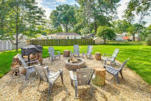 a group of chairs and a fire pit in a yard at Stylish and Modern Lenexa Haven with Fire Pit and Deck! in Lenexa