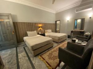 a hotel room with two beds and a living room at VIP Express in University Town