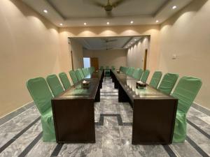 a conference room with a long table and green chairs at VIP Express in University Town