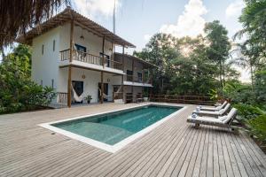 a villa with a swimming pool and a house at Casa Angelina in Trancoso