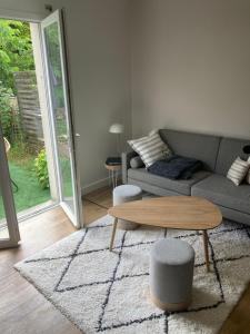 a living room with a couch and a coffee table at Appartement d'Exception à 20m de la Plage Votre Évasion Parfaite in Saint-Brevin-les-Pins +11 photos