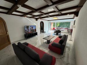 a living room with a couch and a tv at TF Schwarzwald in Bad Säckingen
