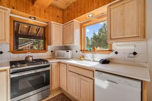 a kitchen with wooden cabinets and a sink and a stove at Mountain Getaway with Granny Unit, Dogs Ok #47 in Bear Valley +26 photos