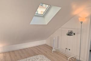 an attic room with a skylight and a window at Cozy Paris Gateway Studio with free parking in Vitry-sur-Seine