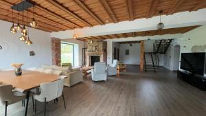 a living room with a couch and a table at Juku Dzirnavas in Zutēni