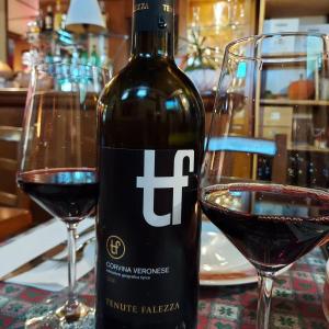 a bottle of wine next to two glasses of red wine at Locanda Chiocciola By Manuel Ronzani in Quero +16 photos