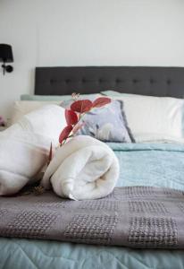 a stuffed animal is sitting on top of a bed at City Break - Luxury Golf Estate & Country Club in Johannesburg