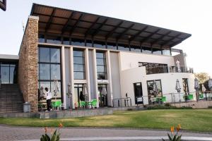 a large white building with people standing outside of it at City Break - Luxury Golf Estate & Country Club in Johannesburg
