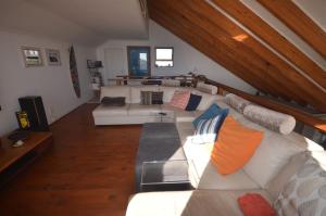 a living room with a white couch with pillows at Clearwater view in Cape Town