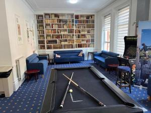 a library with a pool table and bookshelves at Ullswater Hotel in Bournemouth