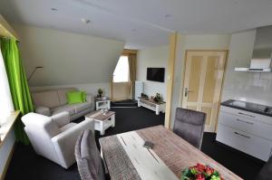 a living room with a couch and a table at Westenwind in Egmond aan Zee
