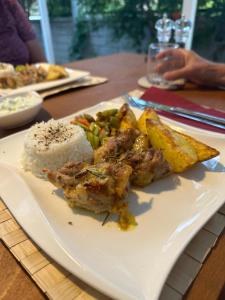a plate of food with rice and meat and vegetables at Blue Eye 5 km from AirPort Dalaman in Dalaman