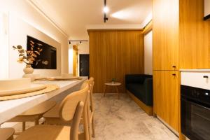 a kitchen and dining room with a table and chairs at Copal Residence in Baia Mare +14 photos