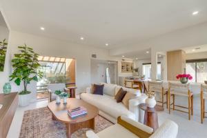 a living room with a white couch and a table at Rancho Mirage Condo Near El Paseo and The River! in Rancho Mirage