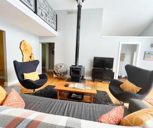 a living room with a couch and chairs and a fireplace at All Points North in Beulah