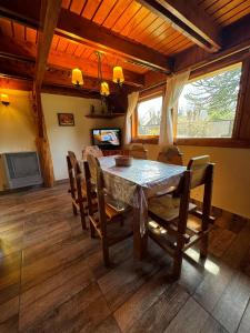 a dining room with a table and chairs at Casa Orion By Los Amancays in Villa La Angostura