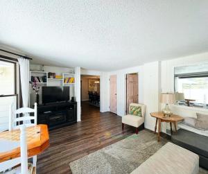 a living room with a couch and a tv at Cherry Blossom Farm in Suttons Bay +20 photos